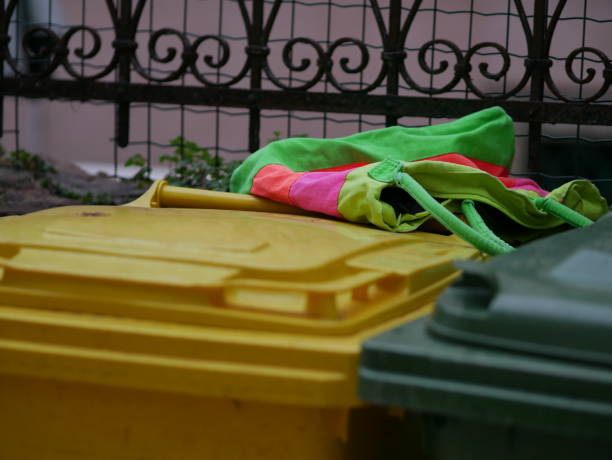 istock A multi-colored cloth bag lies on colored plastic trash cans 2049281530