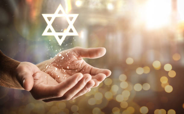 istock Hands and star floating with glitters and religious background 2049299284