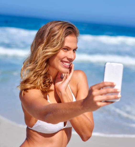 istock A beautiful, young woman having fun at the beach 2049322808
