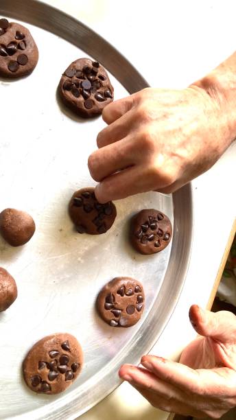 istock Third age man preparing cookies of chocolate chips 2049337067