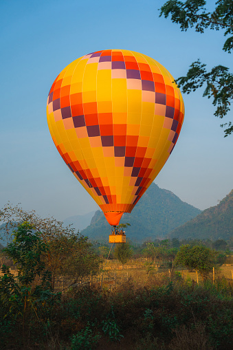 Scenic view of hot air balloon launching from the meadow in Laos