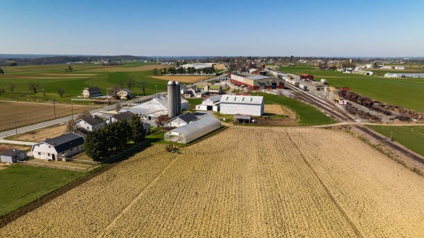 istock Aerial View Of A Farm Complex With Multiple Barns, Silos, And Plowed Fields In A Rural Setting 2049470407