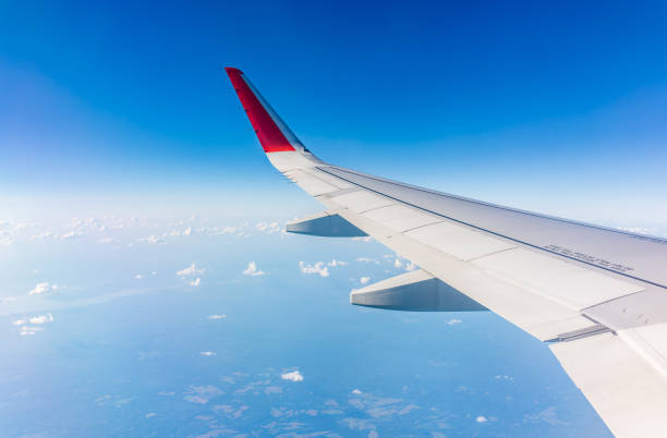 istock View from the airplane window at a beautiful cloudy sky and the airplane wing 2049480187