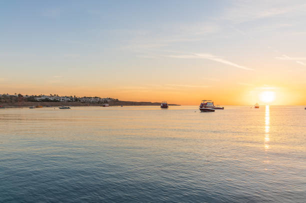 Sunrise over the sea. Panoramic seascape. Burning sky and shining golden waves. Sun over sea