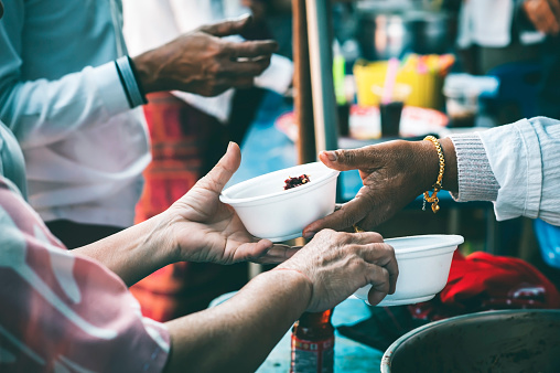 Volunteers distribute free food to the poor : charity food ideas