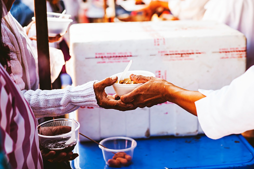 Volunteers distribute free food to the poor : charity food ideas