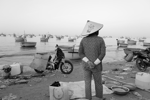 Mui Ne, Vietnam - Feburary 2, 2024: Local women trading on the beach of Mui Ne, Vietnam