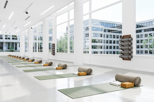 Empty Yoga Studio Interior With Close-up View Of Exercise Mats, Pillows And Yoga Blocks