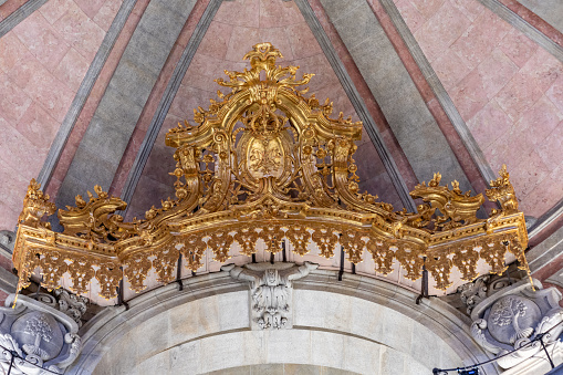 Segovia, Spain, 03.10.21. The Chapter House in Segovia Cathedral, decorated with woven cloth tapestries and coffered ceilings. Bishop seat and image of a Christ in the middle.