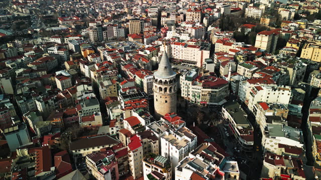 Drone Shot of Galata Tower Amidst Buildings In Crowded City on Sunny Day