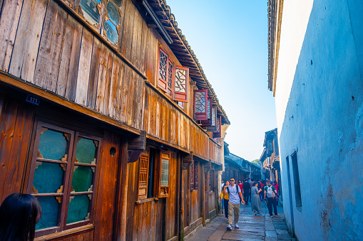 Jiaxing City, Zhejiang Province, China - November 16th 2019: Photo of Tourist Scenery of  Wuzhen  ancient town, People are visiting very ancient houses in sunny day