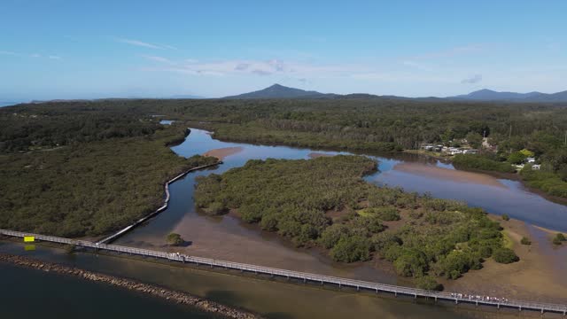 Aerial views of Urunga boardwalk along the banks of the Kalang River, to the junction with the Bellinger River and out to the ocean