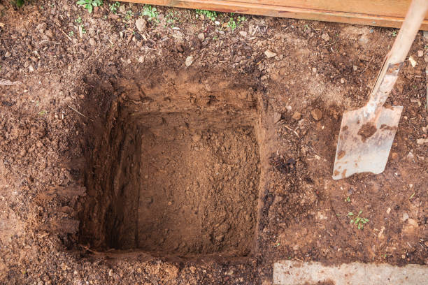 istock Hole in a soil, prepared for planting or construction, pit in a ground with shovel 2049764221