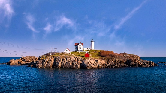 Located on Cape Neddick Nubble Island off the coast of York, Maine, the iconic “Nubble Light” is one of the most photographed lighthouses in New England.