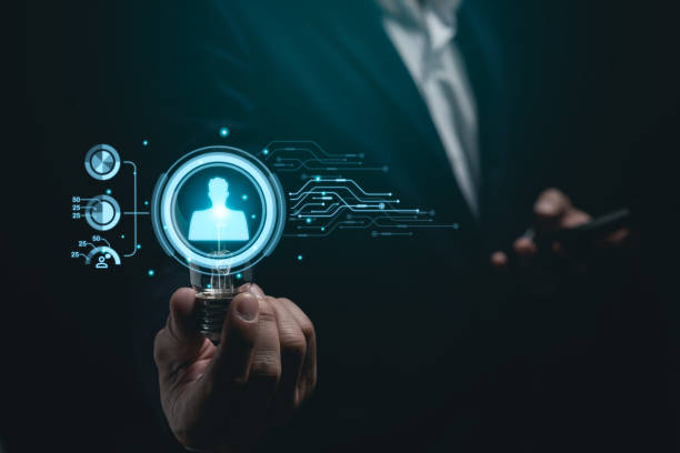 istock Businessman working on laptop and hold light bulb virtual screen human resources digital network hologram. Digital HR Network. HR Human resources find employee or worker concept. 2049825116