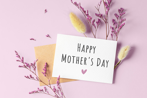 Happy mother day card with flower on pink background, top view