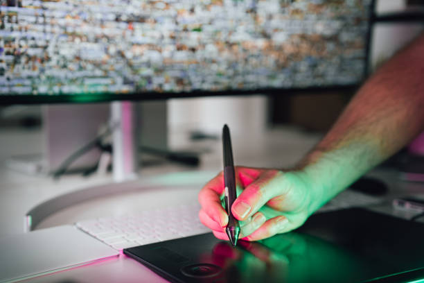 istock Graphic designer. Hand holding a graphics tablet pen. 2049852708