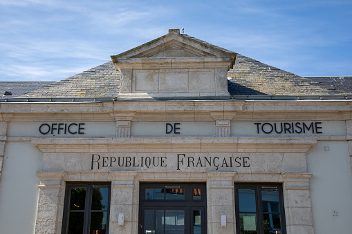 office de tourisme republique francaise in French text means french republic tourist office sign on wall agency facade building