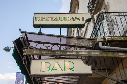 vintage bar restaurant sign text on wall eatery pub coffee in city street storefront building entrance