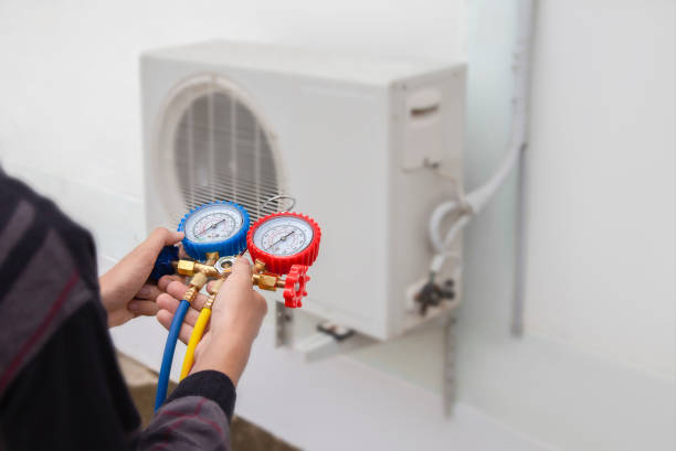 istock Air conditioning, HVAC service technician using gauges to check refrigerant and add refrigerant. 2049876273