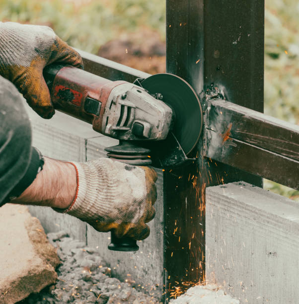 istock A worker is cutting metal to install a fence 2049882002