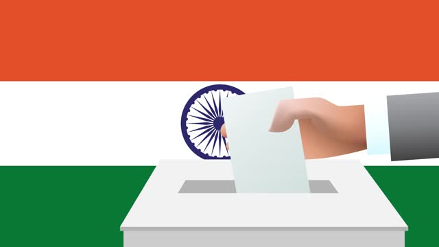 Man putting ballot in a box during elections in India in front of flag.