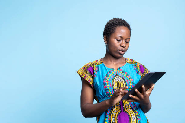 istock African american modern girl feels satisfied using a tablet over blue background 2049933781