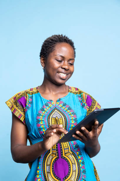 istock Young person explores social media posts on blue backdrop using portable device 2049934353