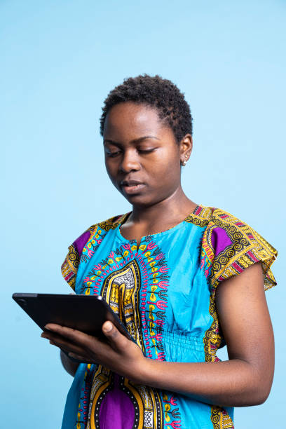 istock African american woman is using a modern tablet in studio 2049935397