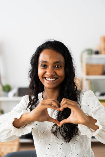 istock Young woman doing heart shape with hands 2049935433