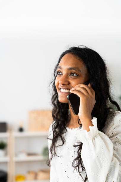 istock Vertical frame of Indian woman talking on phone. 2049935963