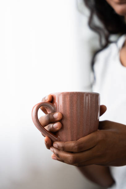 istock Unrecognisable woman holding cup 2049937628