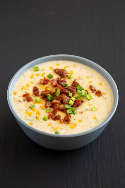 istock Homemade Corn Chowder with Bacon in a Bowl on a black background, side view. 2049947739
