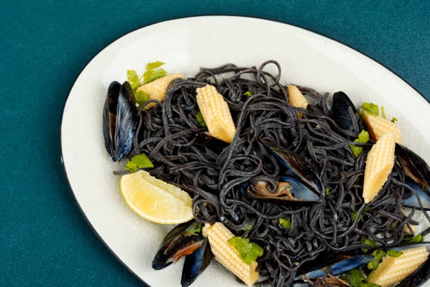 Black pasta with mussels and clams. stock photo