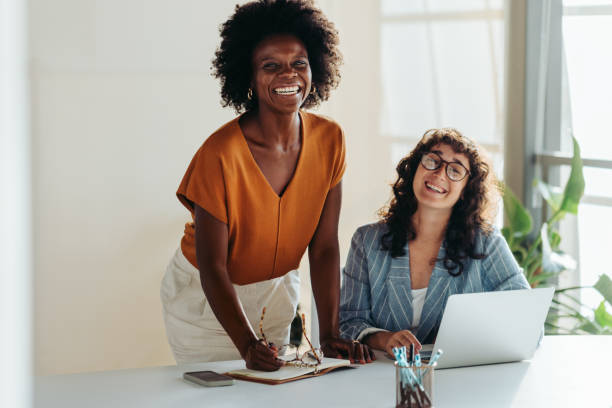 istock Happy female colleagues collaborating in a bright office setting 2049963612