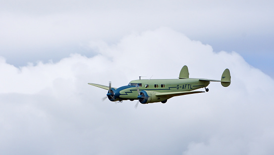 Little Gransden, Cambridgeshire, England - August 27, 2022: Vintage Lockheed 12A Electra Junior in flight
