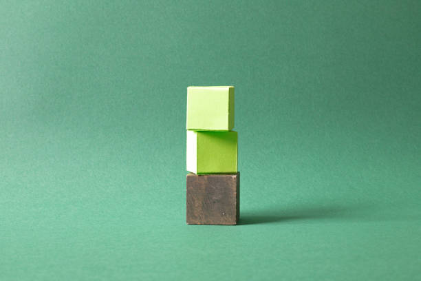 istock Arranged Green Cubes Casting Shadows on Green Teal Surface - Abstract Design Representing Eco-Friendly Development 2049974100