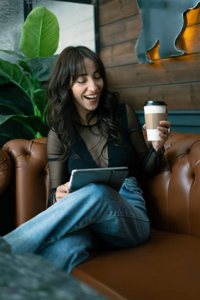 istock Laughing woman working with digital tablet 2049983215