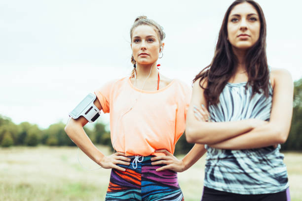 Sporty girlfriends couple jogging and training in a park in London