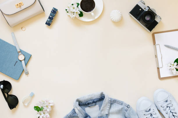 istock Vacation planning concept still life. Clothes, a cup of coffee, a camera and a notepad with a pen on a beige background with a copy space 2050018710