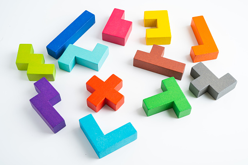 Logical thinking and problem solving creative business solution concept, wooden puzzle geometric shape block shape.