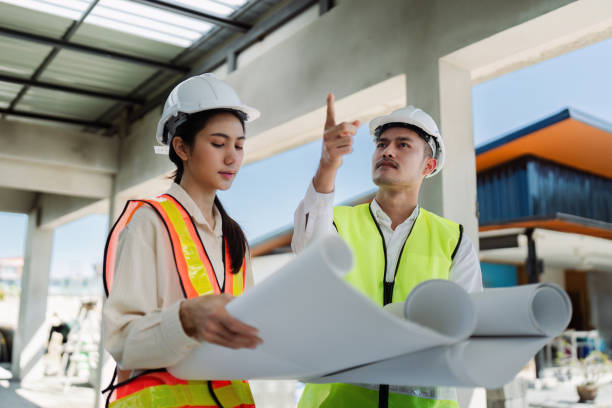 istock team engineer, foreman, architect meeting for colleagues discussing and checks construction blueprints at onsite 2050032767