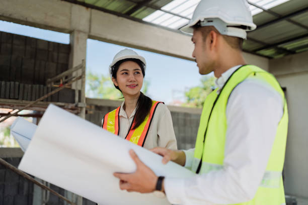 istock team engineer, foreman, architect meeting for colleagues discussing and checks construction blueprints at onsite 2050033285