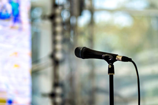 istock Microphone that is on stand in front of blurry background 2050033297