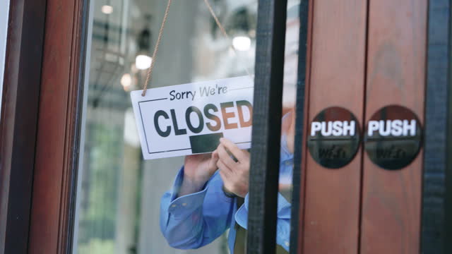Asian Business Owner Smiling Behind Glass Door with Open Sign - Welcoming Customers to Shop