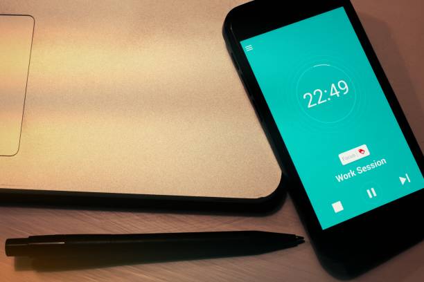 istock Pomodoro Technique Time Management App. Hands to start the tomato timer on the smartphone screen. Used to improve work 2050039294