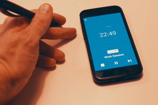 istock Pomodoro Technique Time Management App. Hands to start the tomato timer on the smartphone screen. Used to improve work 2050042603