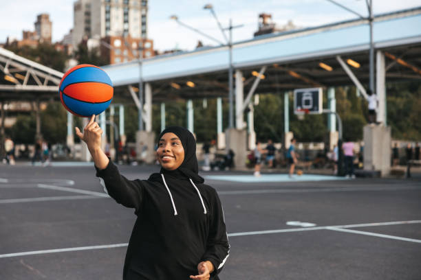 istock Arab basketball player spinning ball on finger 2050053386