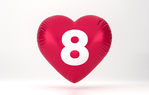 Heart-shaped red flying balloon with the word 8 written on it. International Womens Day Concept.