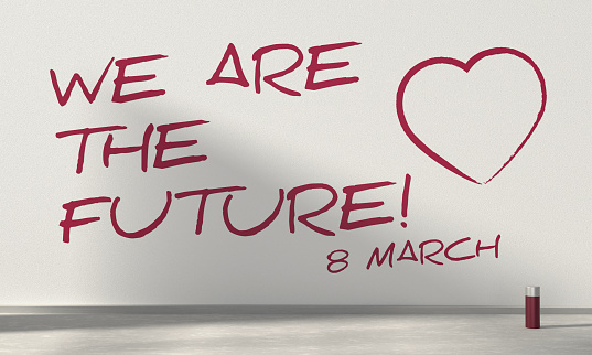 The words “WE “ARE THE FUTURE” were spray-painted on the wall. International Womens Day Concept.